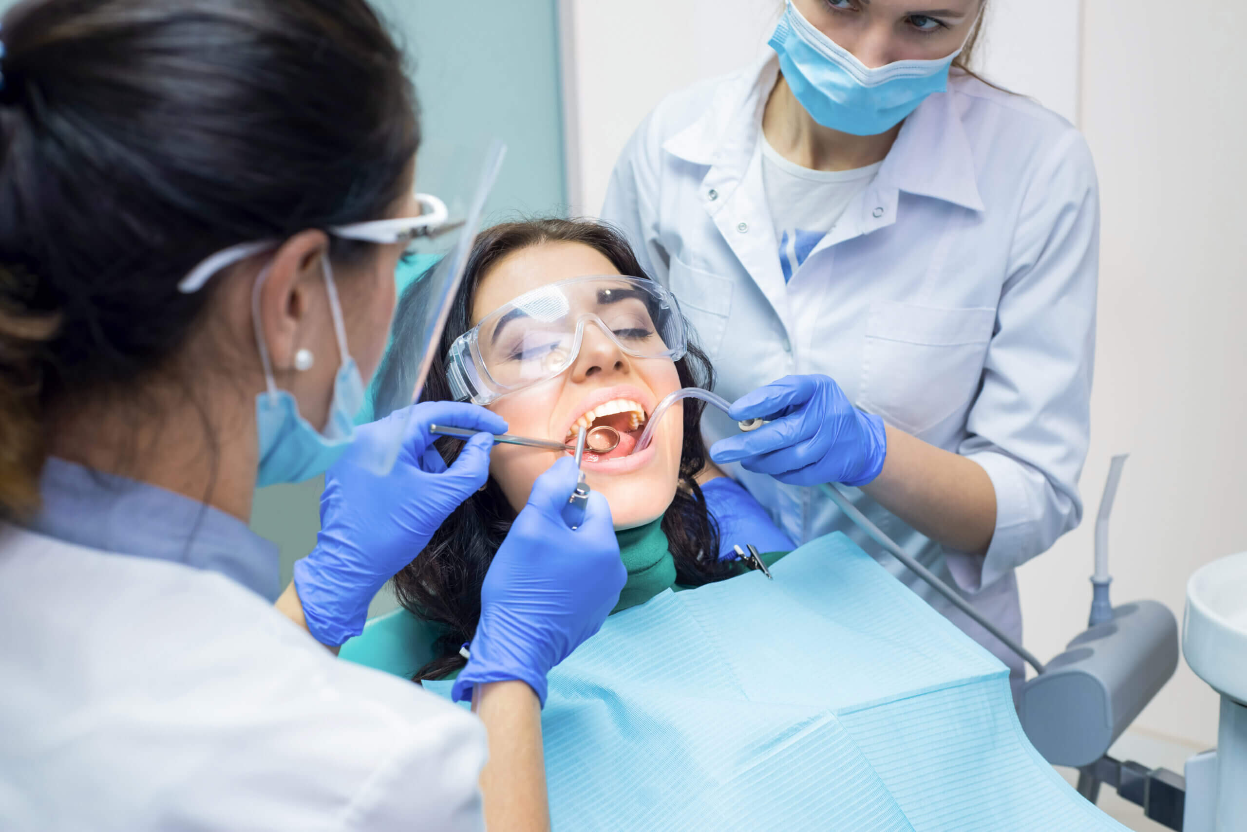Two dental doctors and patient.