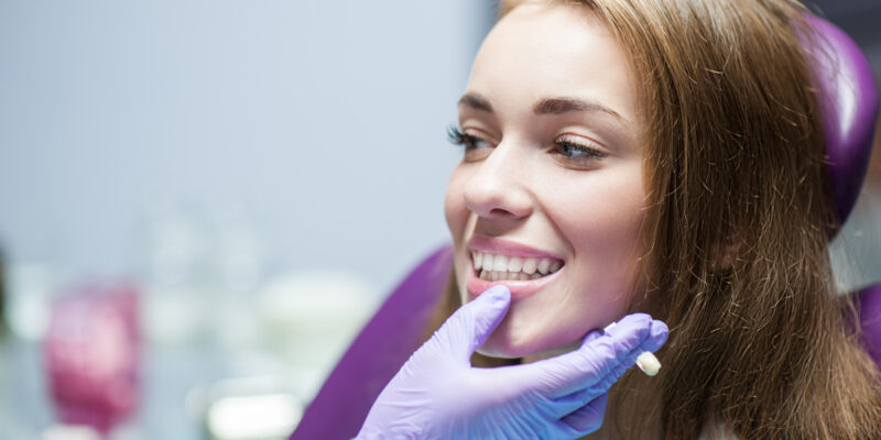 Dentist curing a woman patient in the dental office in a pleasant environment