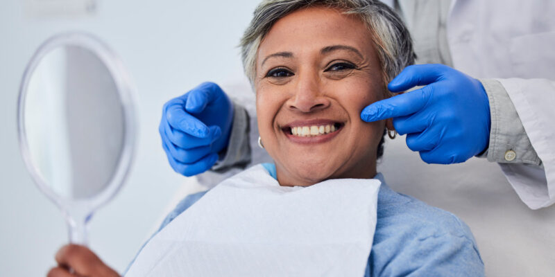 Happy senior woman, teeth and dentist for dental care, appointment or checkup at clinic. Portrait of elderly female person smile for tooth whitening, cleaning or oral, mouth and gum care at hospital.