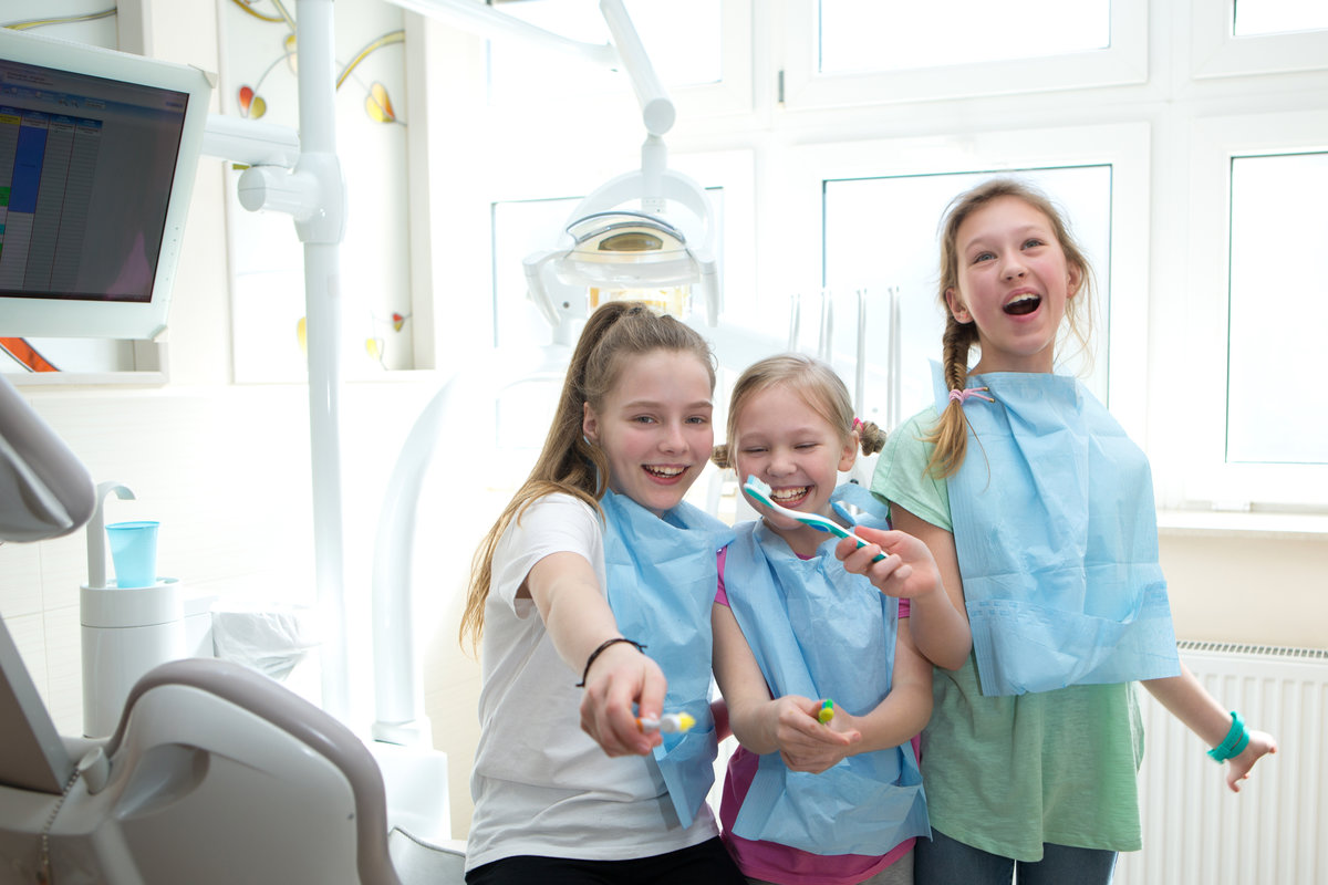 Three girls at a dental office