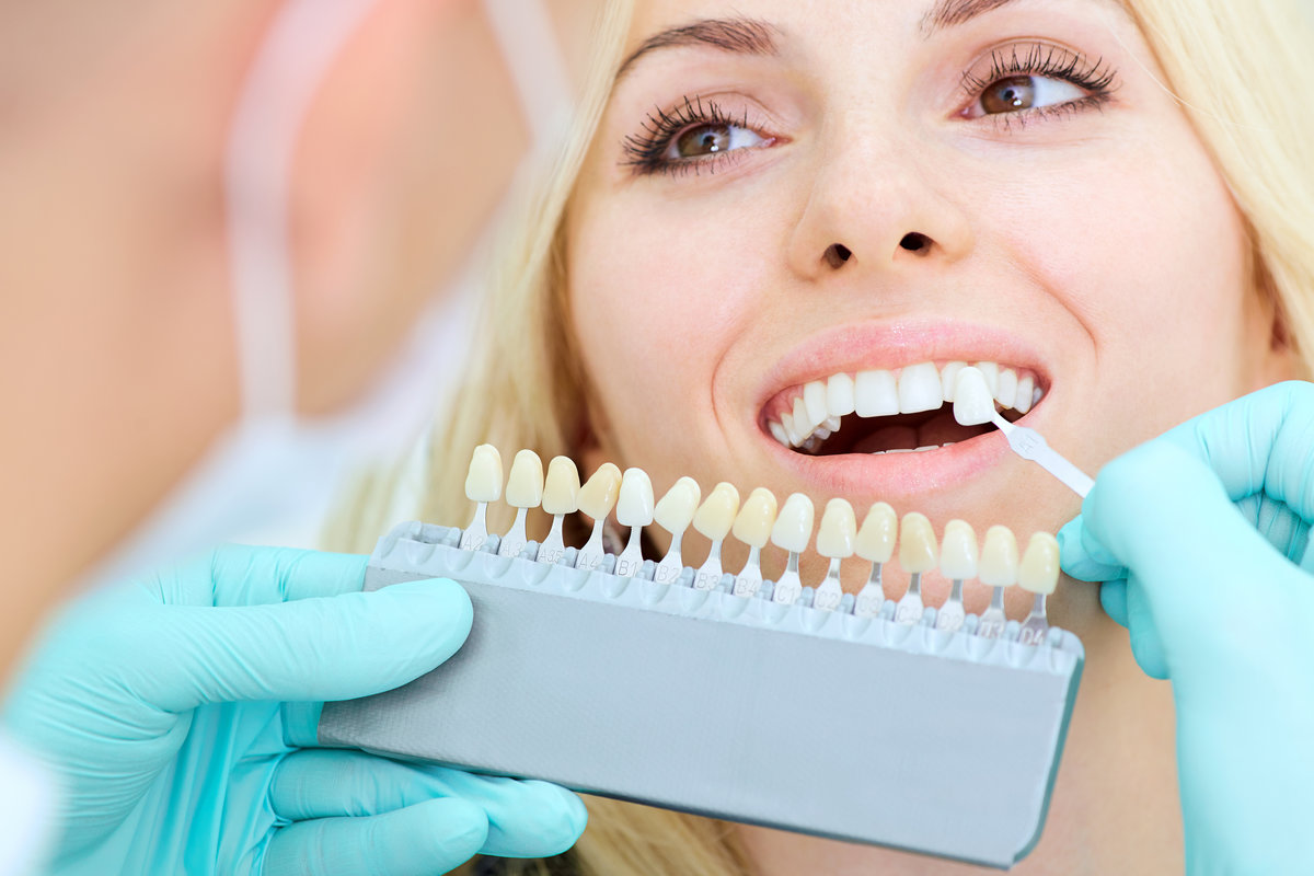 Closeup of a girl with a beautiful smile at the dentist. Dental care concept