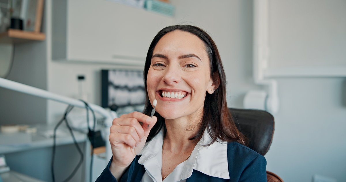 Happy woman, portrait or patient in dental clinic for crown, veneers or medical procedure. Appointment, smile or person with implant in oral exam for dentistry, teeth whitening or cosmetics treatment.