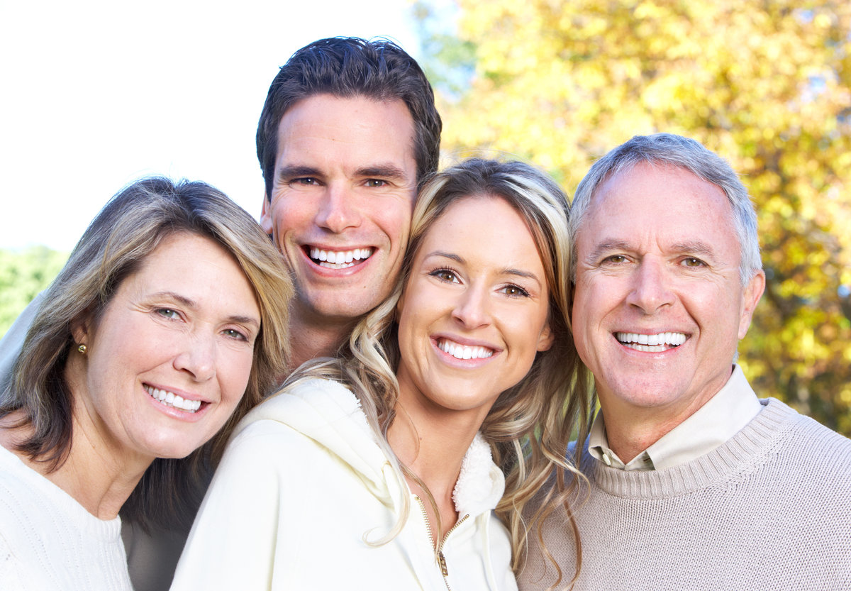 Happy family in park. Father, mother, son and daughter