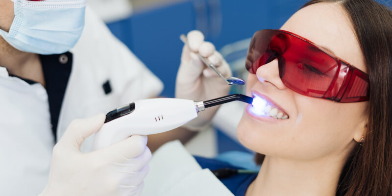 Female patient visiting the dentist for a teeth whitening treatment in a clinic